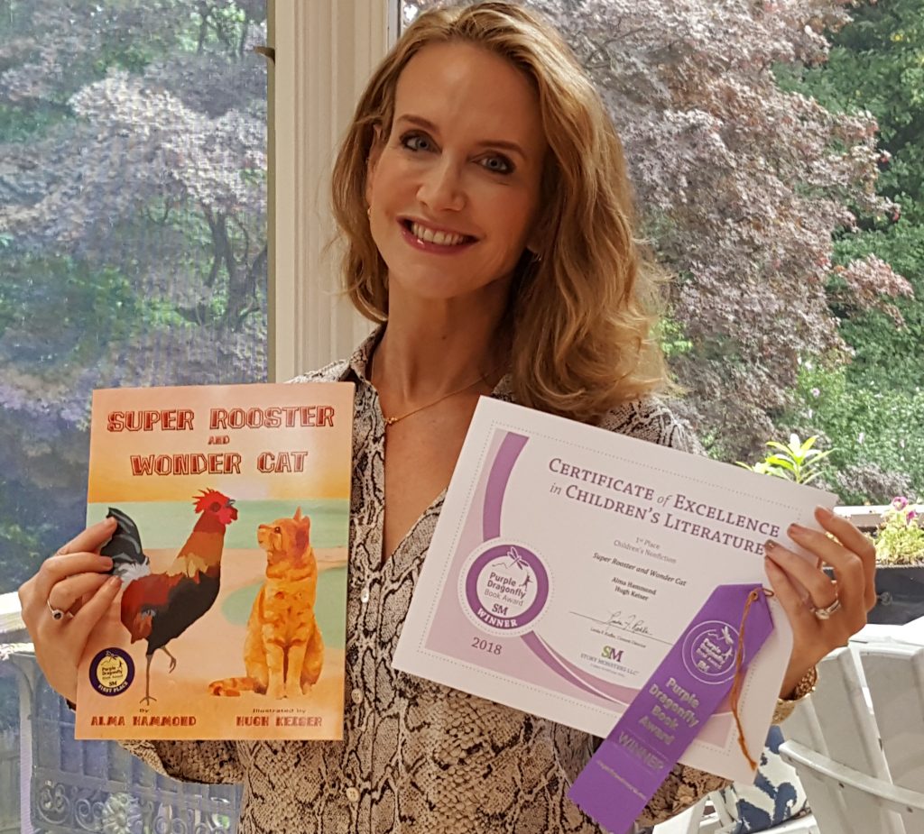 Alma Hammmond, children's book author, holding her book and her award